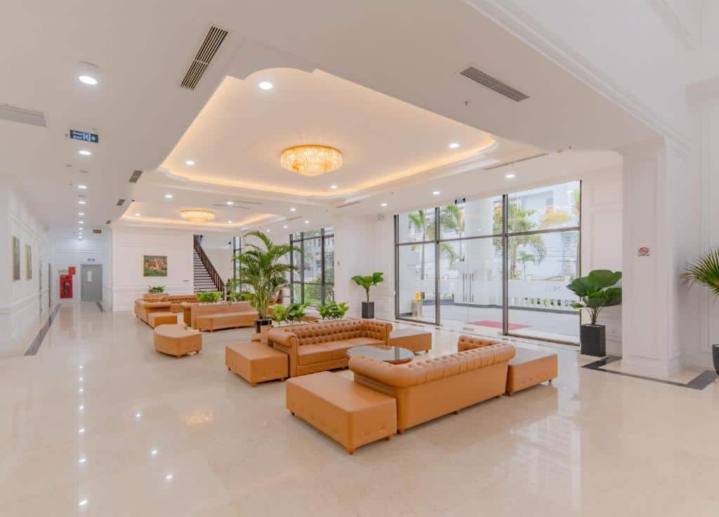 Modern hotel lobby with plush beige seating, large windows, and elegant lighting, creating a welcoming atmosphere for guests at HANSA by HANSA Global.